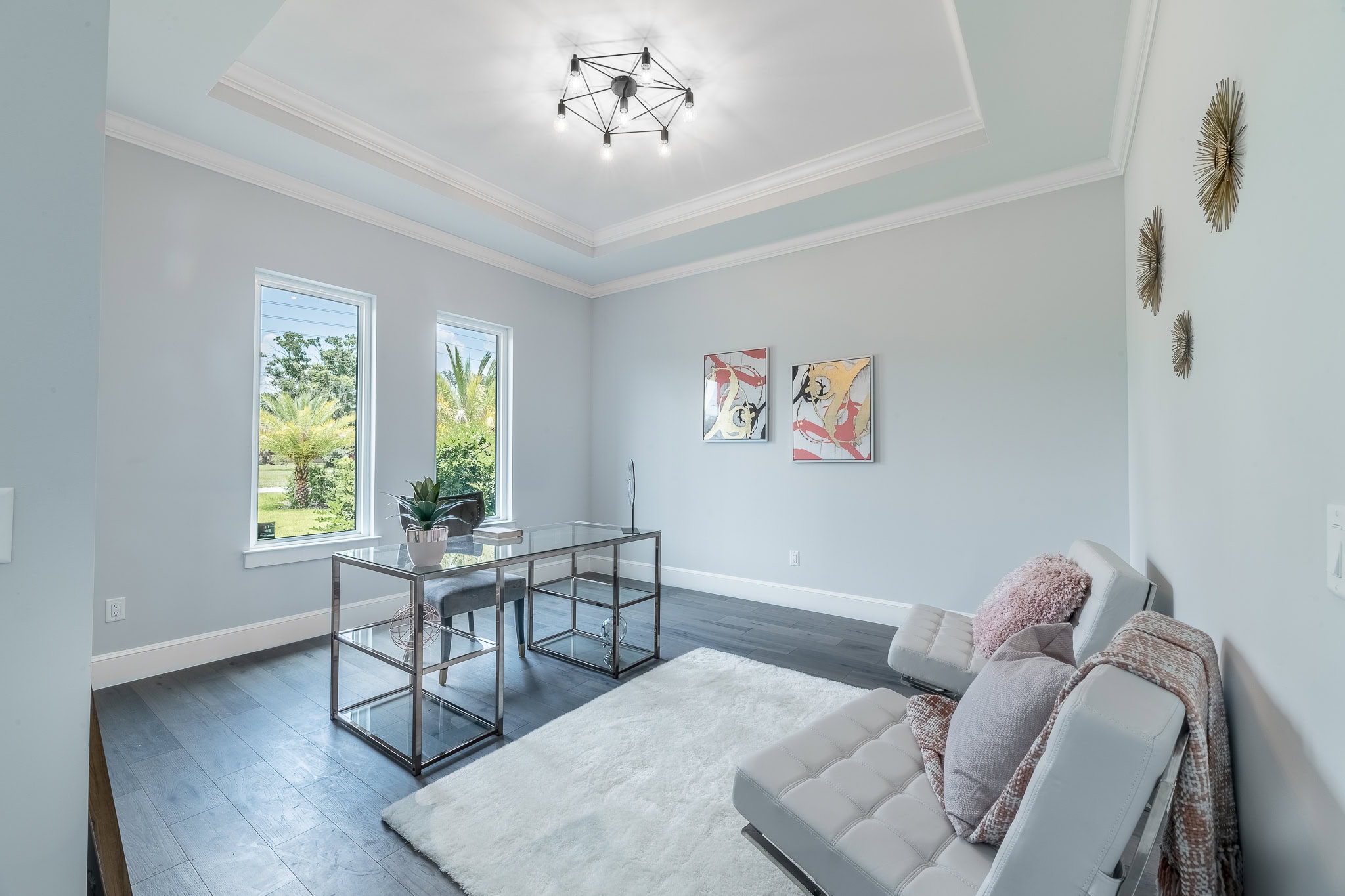 Home office with glass desk in a Queen Homes custom-built home in Orlando, FL